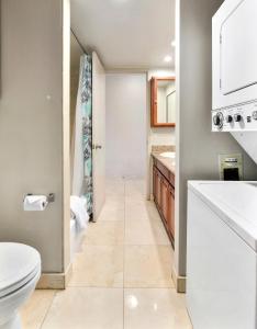 a bathroom with a toilet and a sink at Waikiki Beach Condominiums in Honolulu