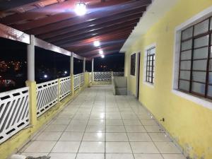 a balcony with a view of the city at night at CAPIVARI POUSADA B&B in Capivari