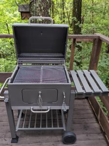 a barbecue grill sitting on a wooden deck at Asuka's House 八ヶ岳 in Hokuto