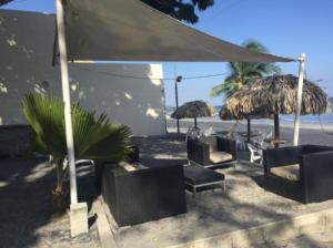 a group of chairs and umbrellas on the beach at Private family room in Coronado Luxury Club & Suites in Playa Coronado