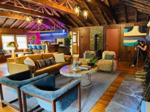 a person taking a picture of a living room at Peaceful Getaway Cottage on grounds of historic mid-century gem in Northborough