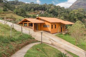 a house on a hill with a road at Pousada Recanto da Serra in São Pedro da Serra