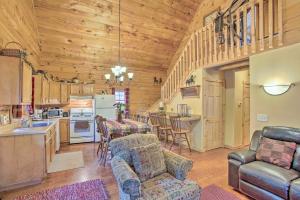 a kitchen and living room with a table and chairs at Resort Cabin with Fire Pit Golf, Hike and Play! in Rothbury