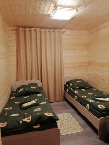 a bedroom with two beds in a cabin at Гостевой дом в лесу in Tavda
