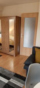 a living room with a couch and a bedroom at NAPKŐ APARTMAN in Sopron