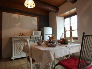 a dining room with a table with a white table cloth at Gîte Saint-Paulien, 4 pièces, 6 personnes - FR-1-582-266 in Saint-Paulien