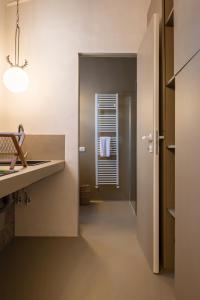 a bathroom with a sink and a window at Boudoir degli Orti, Unconventional Stay in Borgata, Siracusa in Siracusa
