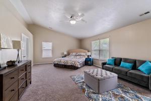a bedroom with a bed and a couch at Incredibly Spacious Carmel Home with Fully Equipped Kitchen - 4700 Sq Ft! Sleeps 15! Pet Friendly! home in Carmel