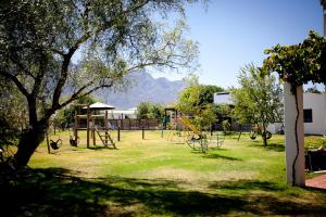 a park with a swing set and a playground at Eikelaan Farm Cottages in Tulbagh