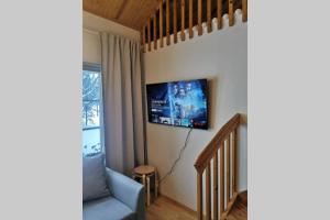 a living room with a tv on the wall at Gold Legend Paukkula#2 - Saariselkä Apartments in Saariselka