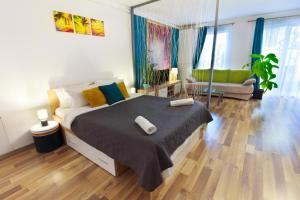 a bedroom with a bed and a living room at Gold Class Apartments AMS in Cluj-Napoca