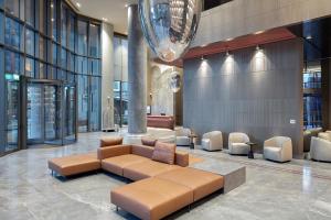 a lobby with a couch and chairs in a building at Melas Hotel Istanbul in Istanbul