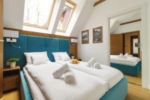 a bedroom with two beds and a mirror at Kuźnice Residence in Zakopane