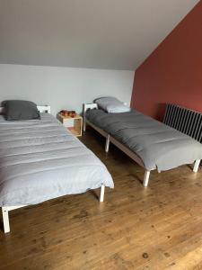 2 Betten nebeneinander in einem Zimmer in der Unterkunft Gîte les Retrouvailles in Saint-Quentin-Lamotte-Croix-au-Bailly