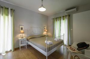 Postel nebo postele na pokoji v ubytování Villa Elli