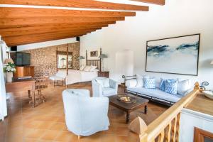 a living room with a blue couch and a table at Finca Ca'n Quatre in Sóller