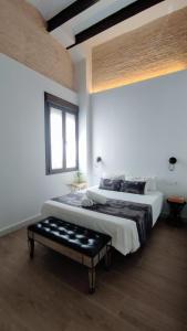 a white room with two beds and a window at Miraflores 58 Apt - Private Parking Opt in Seville