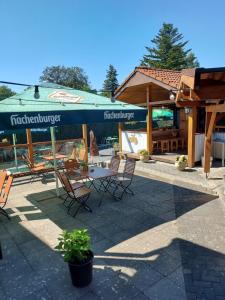 a patio with a table and chairs and a building at Landgasthaus Hubertusklause in Bad Marienberg