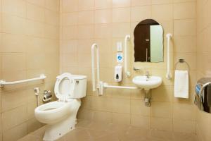 a bathroom with a toilet and a sink at City Hotel Duqm in Duqm