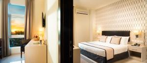 a hotel room with a bed and a window at City Hotel Duqm in Duqm