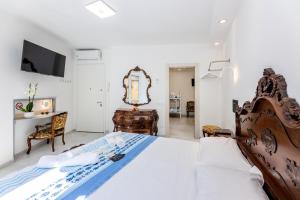 a bedroom with a large bed and a mirror at San Giovanni in Finale Ligure +32 photos