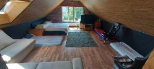 a attic room with two beds and a couch at Voodikoht Viljandis in Viljandi