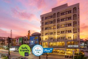 a building with signs in front of a street at Montree Phuket Hotel in Phuket Town