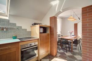 a kitchen with a table and a dining room at APARTAMENT KWIATOWY Krynica Zdrój in Krynica Zdrój