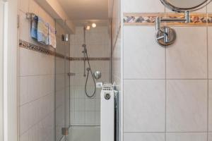 a shower with a glass door in a bathroom at Ferienwohnung Lengdobler - Burgi in Bad Kohlgrub +20 photos