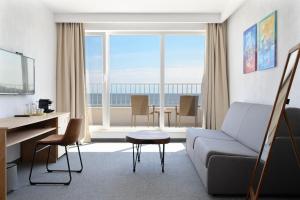 a living room with a couch and a table at JI HOTEL in Sozopol