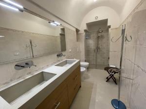 a bathroom with a sink and a shower and a toilet at Casa di Rosaria - Due appartamenti nel centro storico con giardino sul terrazzo in Depressa
