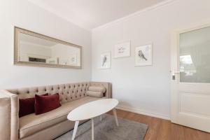 a living room with a couch and a mirror at Elegant near Old Town - free parking in Gdańsk