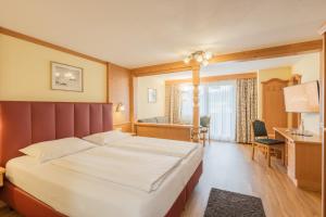 Postel nebo postele na pokoji v ubytování Hotel Schönegg
