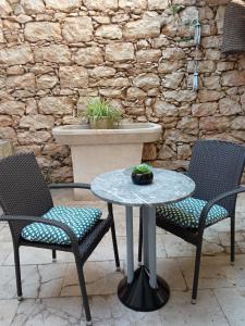 a table and two chairs and a table with a table at Rooms Zela 1 in Korčula +22 photos