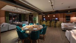 a dining room with a table and chairs at KOMOREBI BAKURIANI RESORT in Bakuriani