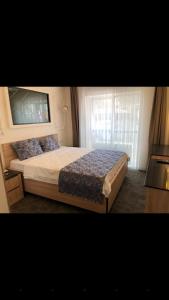 a bedroom with a large bed with a window at AYDINLI HOTEL in Amasya