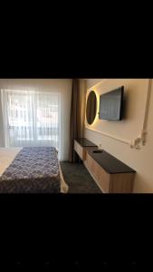 a hotel room with a bed and a television at AYDINLI HOTEL in Amasya