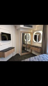 um quarto com 2 espelhos, uma cama e um lavatório em AYDINLI HOTEL em Amasya