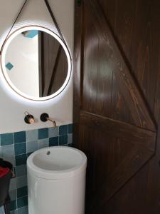 uma casa de banho com um WC e um espelho. em Burbuja AntiSaturno - Glamping Alto Tajo em Ablanque