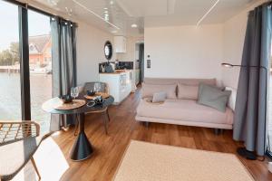 a living room with a couch and a table at Hausboote und Fewo Vieregge in Vieregge