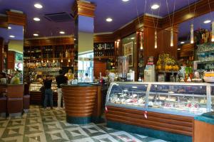 a restaurant with a bar with people standing at a counter at Residenza Ottaviani Roma in Rome