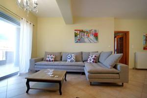 a living room with a couch and a coffee table at KYPARISSIA LUXURY HOME in Kyparissia
