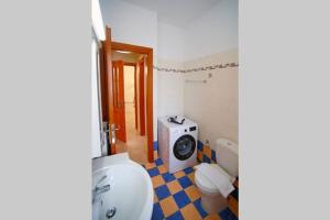 a bathroom with a toilet and a washing machine at KYPARISSIA LUXURY HOME in Kyparissia +45 photos