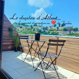 a table and a chair sitting on a balcony at Le duplex d'Albert logement d'exception à Namur in Namur
