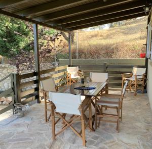 a wooden table and chairs on a patio at Messinia view house in Akhladhokhórion