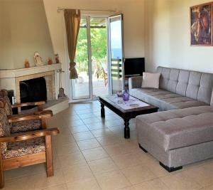 a living room with a couch and a table at Messinia view house in Akhladhokhórion