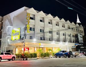 a hotel with cars parked in front of it at Keeree Boutique Hotel in Phetchaburi