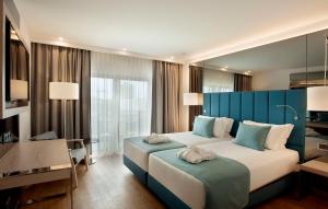 Cama ou camas em um quarto em TURIM Presidente Hotel