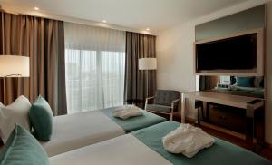 Cama ou camas em um quarto em TURIM Presidente Hotel