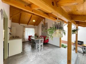 a kitchen and living room with a table and a dining room at Ibolya Apartman in Csisztapuszta +14 photos